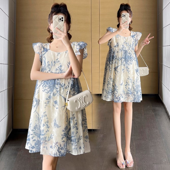 A loose embroidered short-sleeve maternity dress with flutter sleeves in a bohemian A-line style